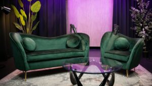 A photo of two green couches on a podcast set