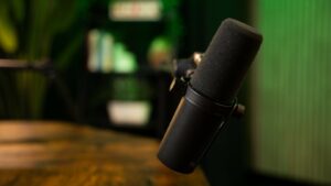 A close up image of a microphone over a wooden table